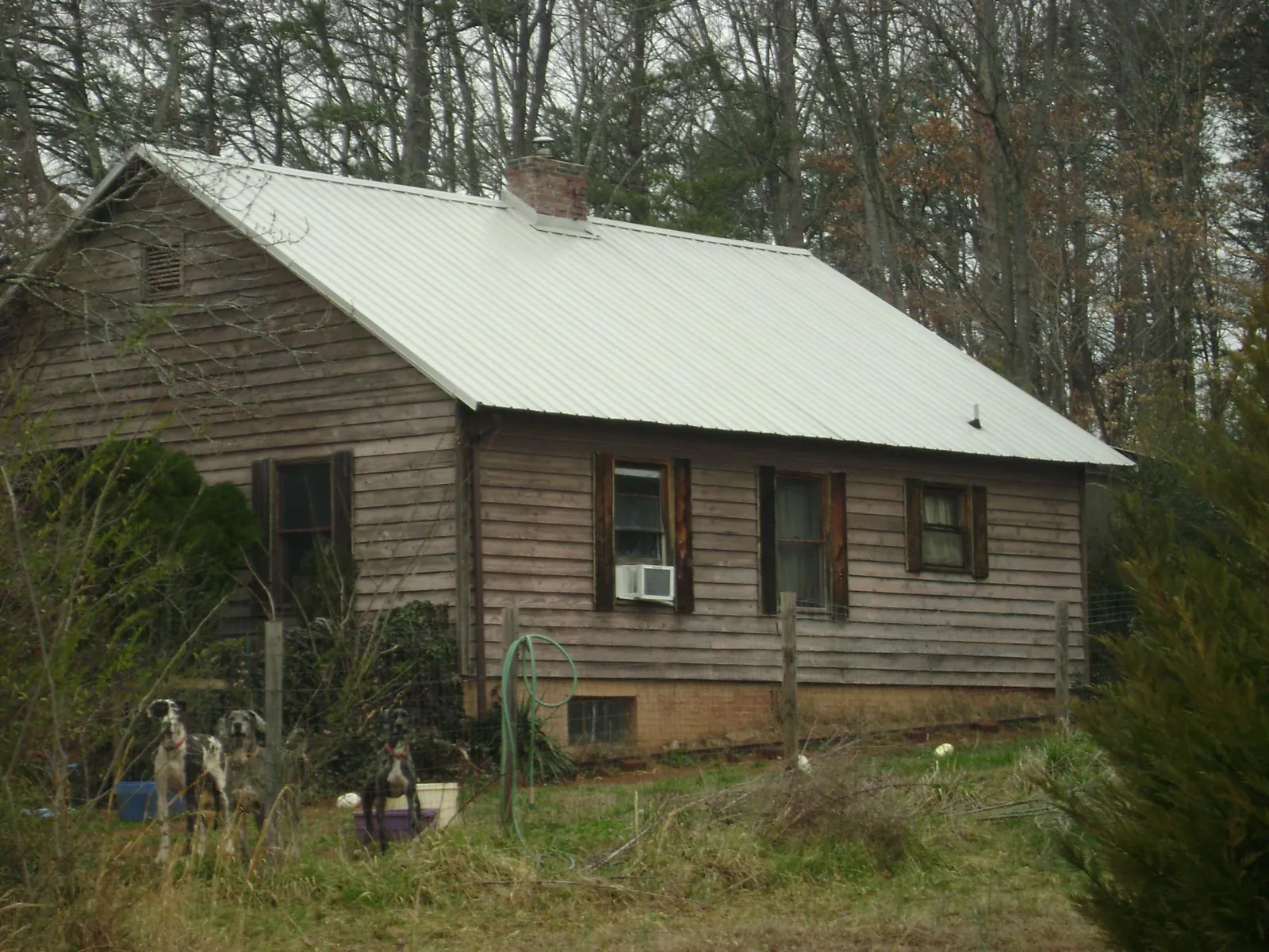 White metal roof on an old wood sided farmhouse, from a Metal Roof Installation job in Manquin